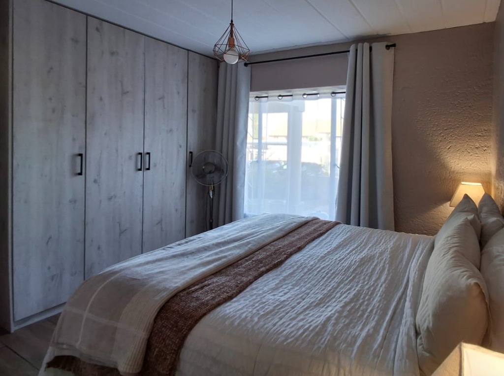 Styled bedside detail and warm light styling - Fay Furnishings